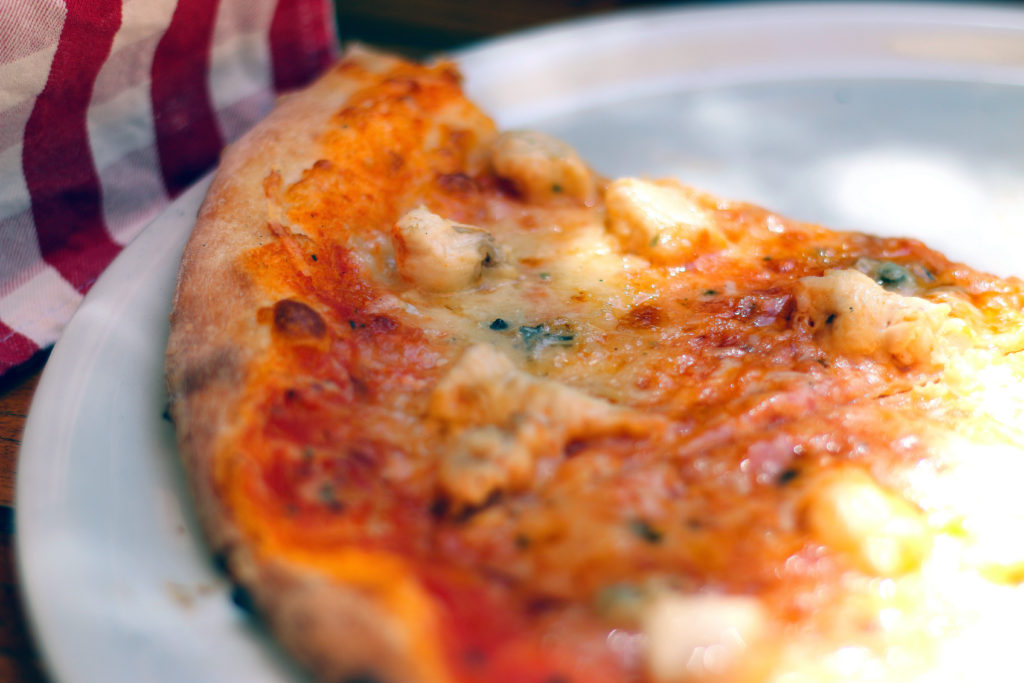 Aslice of New York Pizza on a white plate