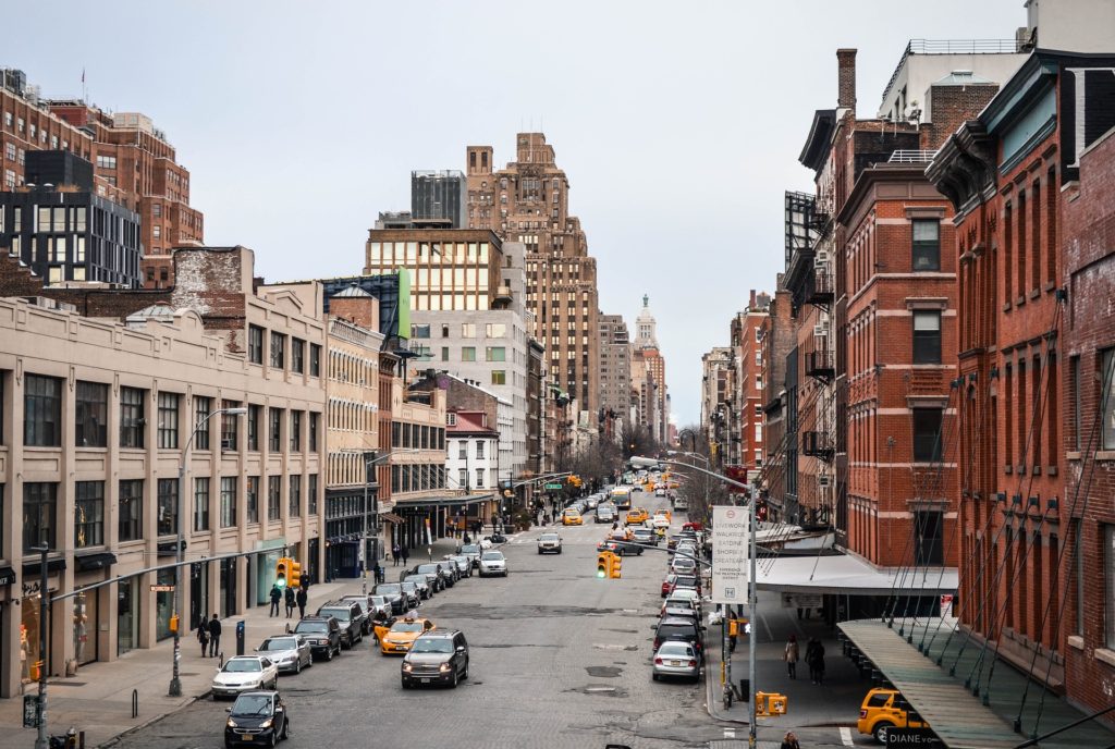 Padestrians and cars head up the street in the meatpacking district NYC