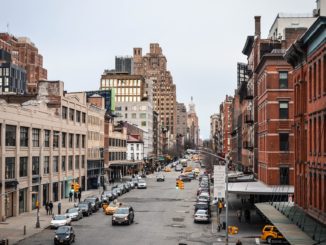 Padestrians and cars head up the street in the meatpacking district NYC