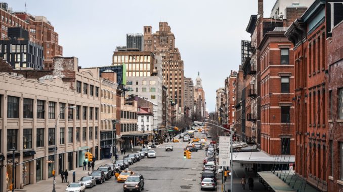 Padestrians and cars head up the street in the meatpacking district NYC