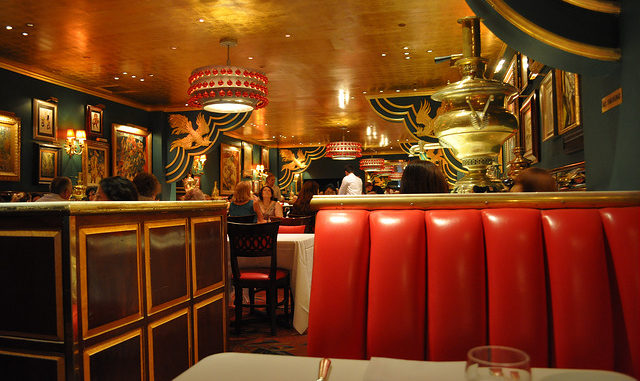 Red leather seats, gold ceiling and green walls decorate the Russian Tea Room NYC