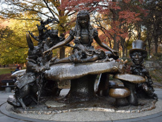 The Alice in Wonderland Bronze Statue in front of trees Central Park