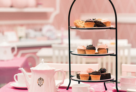 Cakes and tea sit on a table at a Eloise-Themed Afternoon Tea at The Plaza Hotel New York