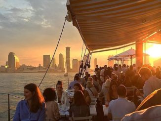 Patrons dining at Grand Banks Oyster Bar located on schooner on the Hudson River.