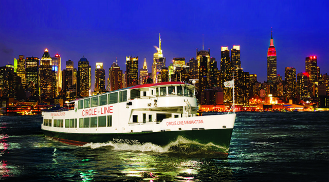 Circle Line Ship sails up the Hudson River with New York skyline in background