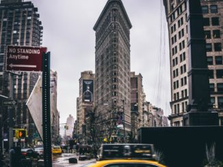 Taxis pass one of New York City’s most unique structures, the Flatiron Building.