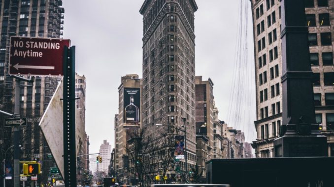 Taxis pass one of New York City’s most unique structures, the Flatiron Building.