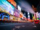 People enjoy New York City’s Times Square at night