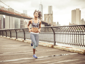 Girl running on the pier with New york skyline in the background