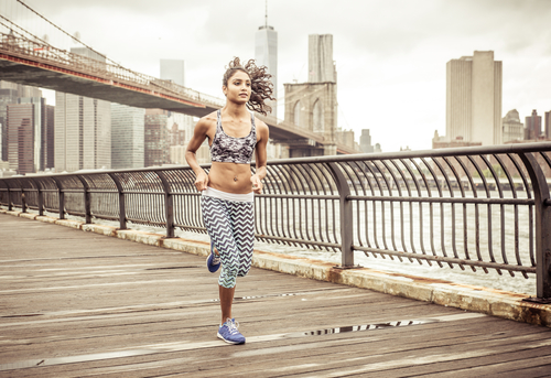 Girl running on the pier with New york skyline in the background