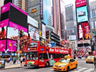Gray Line Sightseeing Bus in New York takes passengers through Times Square