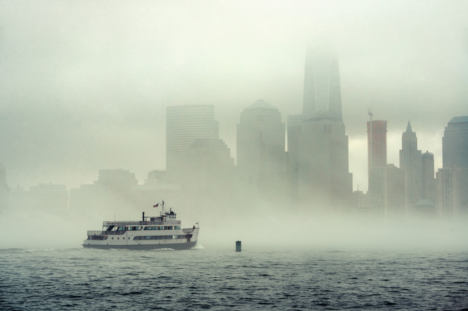 oat on the hudson river in fog during halloween in new york