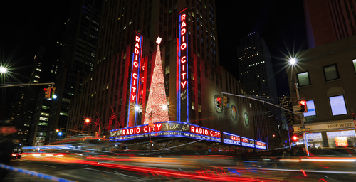 : Bright Christmas lights of Radio City Music Hall in New York City at night.