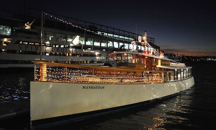 ship sits on pier with orange lights on board