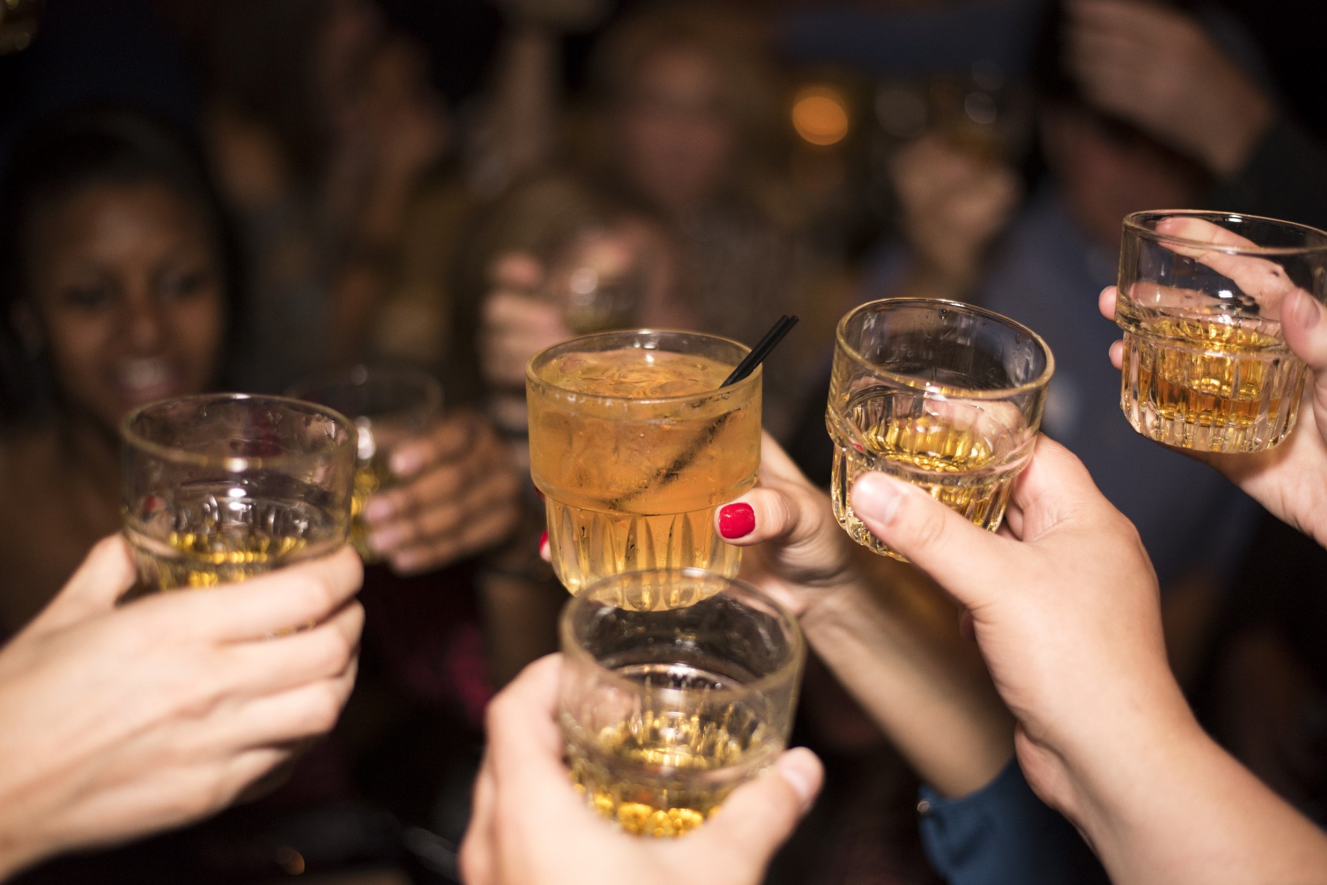 group of people toast whiskey glasses - new york in december