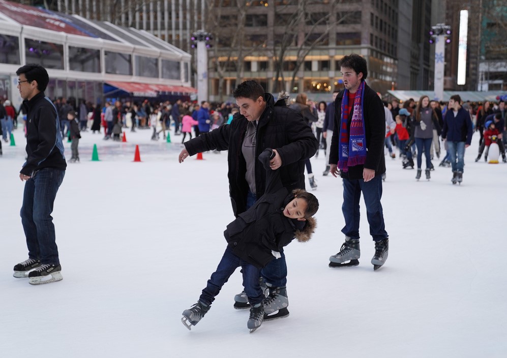 amilies skate on the ice at the Bryant Park ice rink