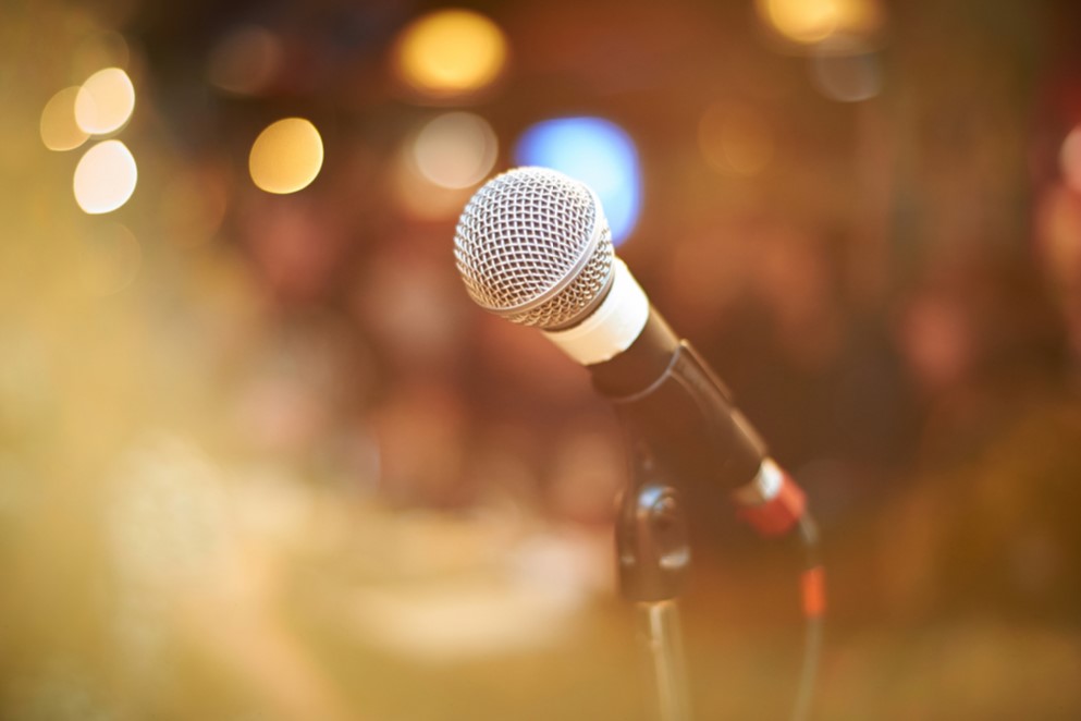 a microphone stands on a stage - new york in november