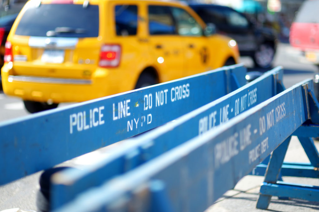 New York yellow taxi behind a police blockade
