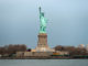 Tourists gather at the base of the Statue of Liberty. New York, USA.