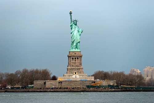 Tourists gather at the base of the Statue of Liberty. New York, USA.