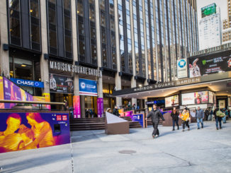 people walk by Outside madison square garden new york