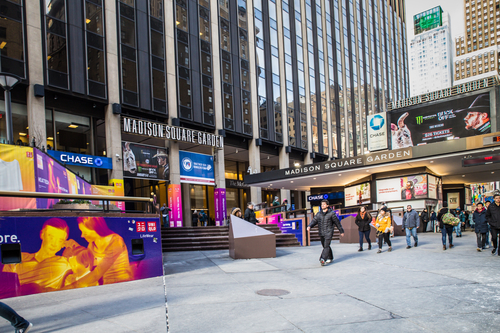 people walk by Outside madison square garden new york