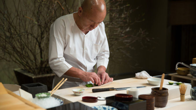 chef at the Masa Restaurant prepares food for diners