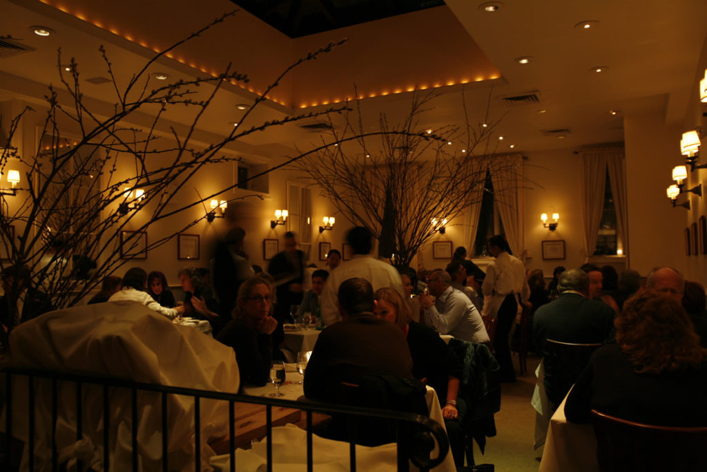 diners sit and chat while waiting for their food Inside Babbo Restaurant New York