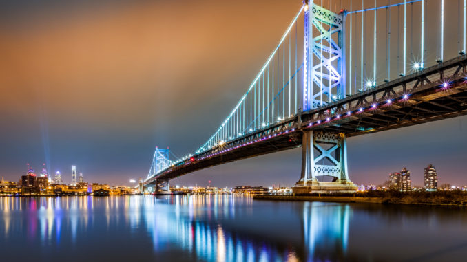 Ben Franklin Bridge and Philadelphia skyline by night as viewed from Camden across the Delaware river