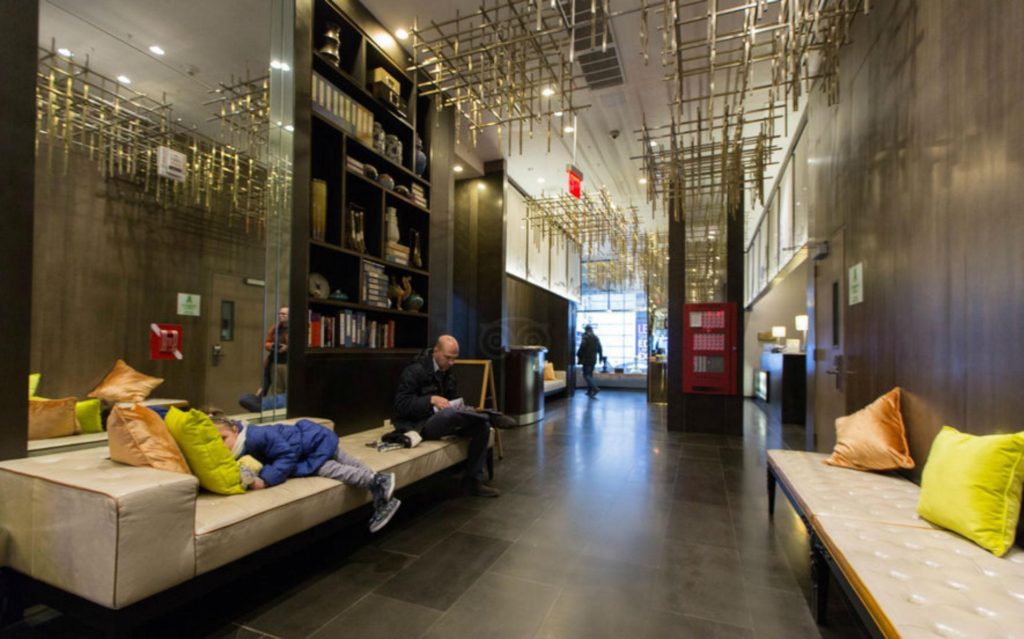 People chill out on sofas in the lobby of the Holiday Inn Financial District