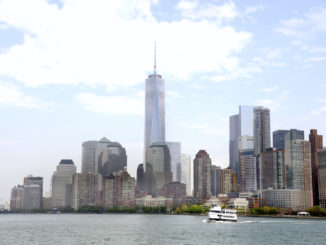 The Manhattan skyline overlooking a cruise ship on the Hudson River - Circle Line Sightseeing Cruises