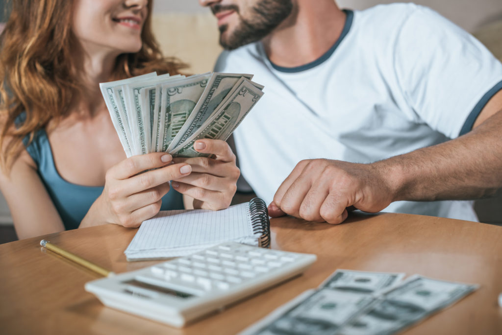 couple holding money budgeting-for-holiday how much spending money new york