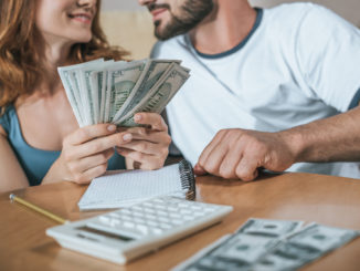 couple holding money budgeting-for-holiday how much spending money new york