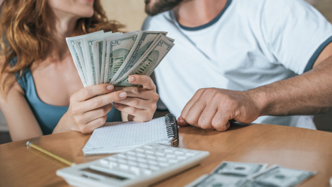 couple holding money budgeting-for-holiday how much spending money new york