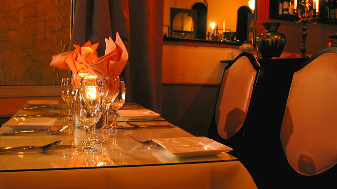 candle lit table ready for diners to arrive at one of the most romantic restaurants in new york