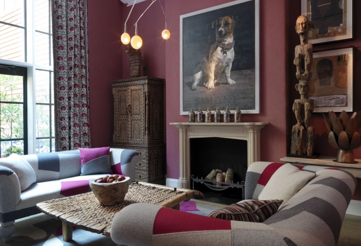 beautifully-decorated room with nice sofas a huge pic of dog on the wall