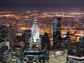 the Chrysler Building, along with the rest of New York, lit up at night