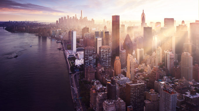 view over new york city with sun rising over skyscrapers