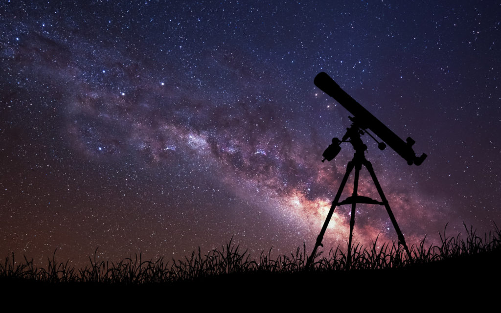 telescope points into the sky on a clear night