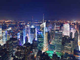 areal shot of Manhattan by night with all the major attractions illuminated