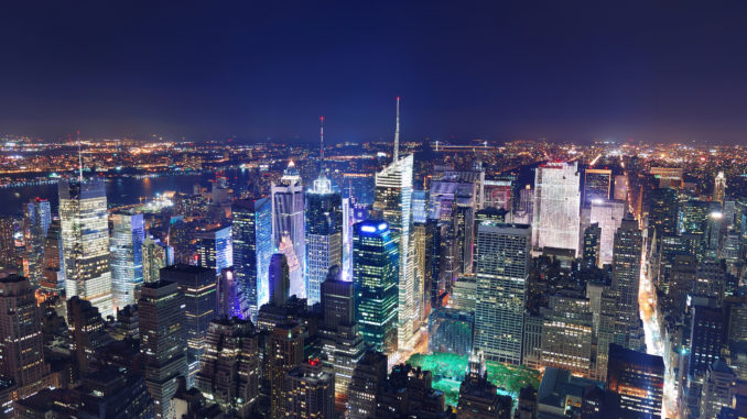 areal shot of Manhattan by night with all the major attractions illuminated