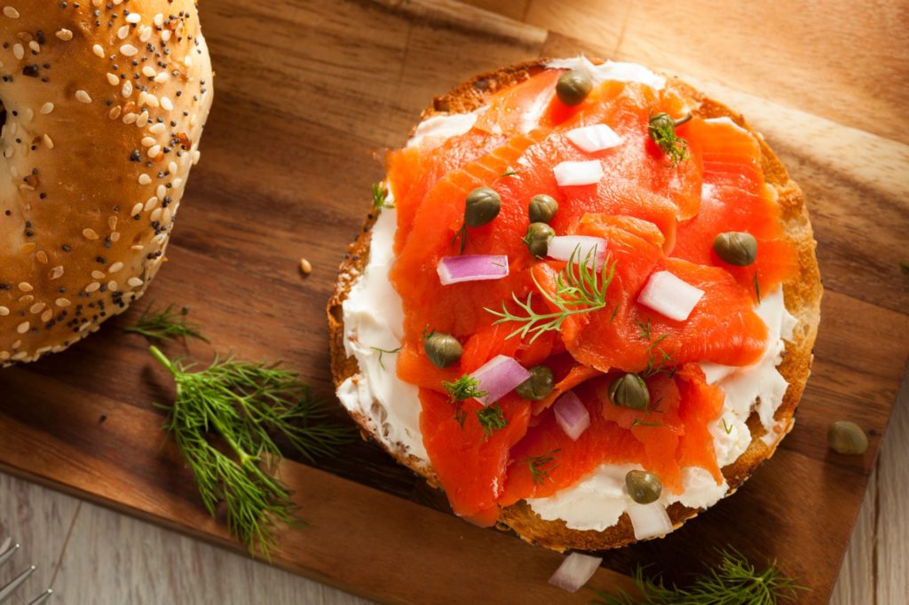 bagel topped with cream cheese a lox - things to eat in new york