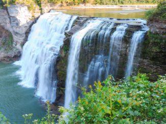 water comes over the rocks in a waterfall at letchworth, one of the best national parks in new york