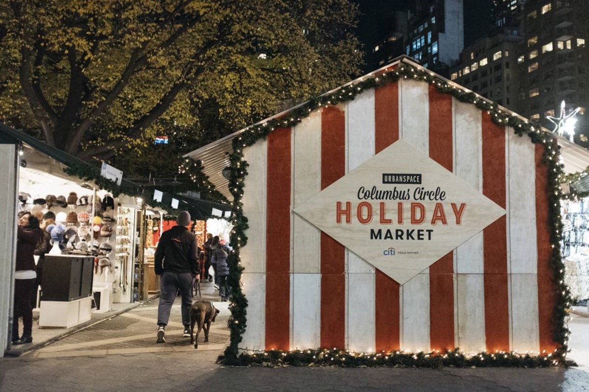 people shopping at holiday market in new york in november