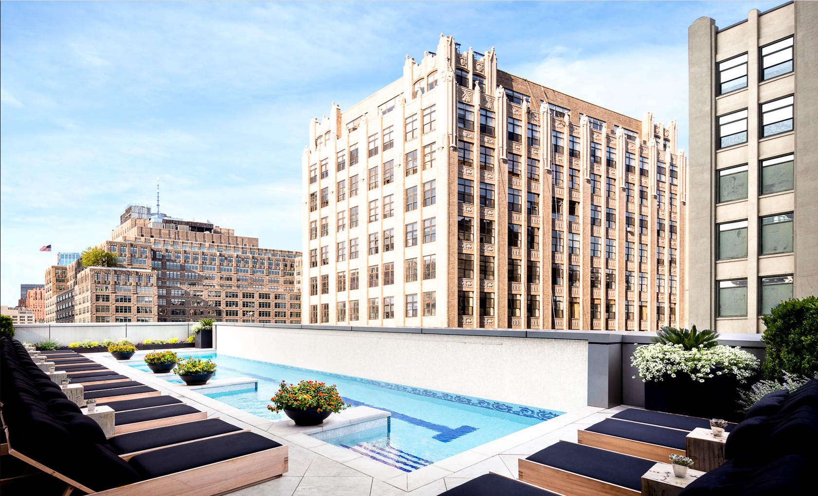 Rooftop pool surrounded by sun loungers