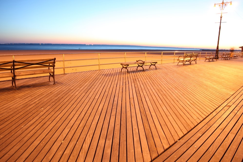 Empty boardwalk and benches in front of Brighton Beach