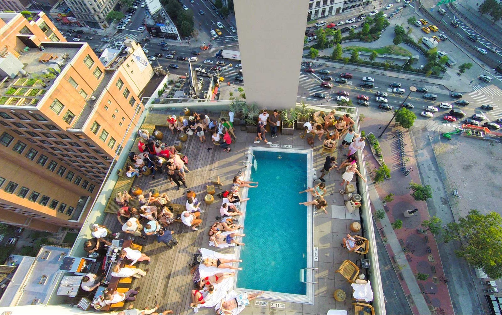 Aerial shot of pool party on a rooftop bar