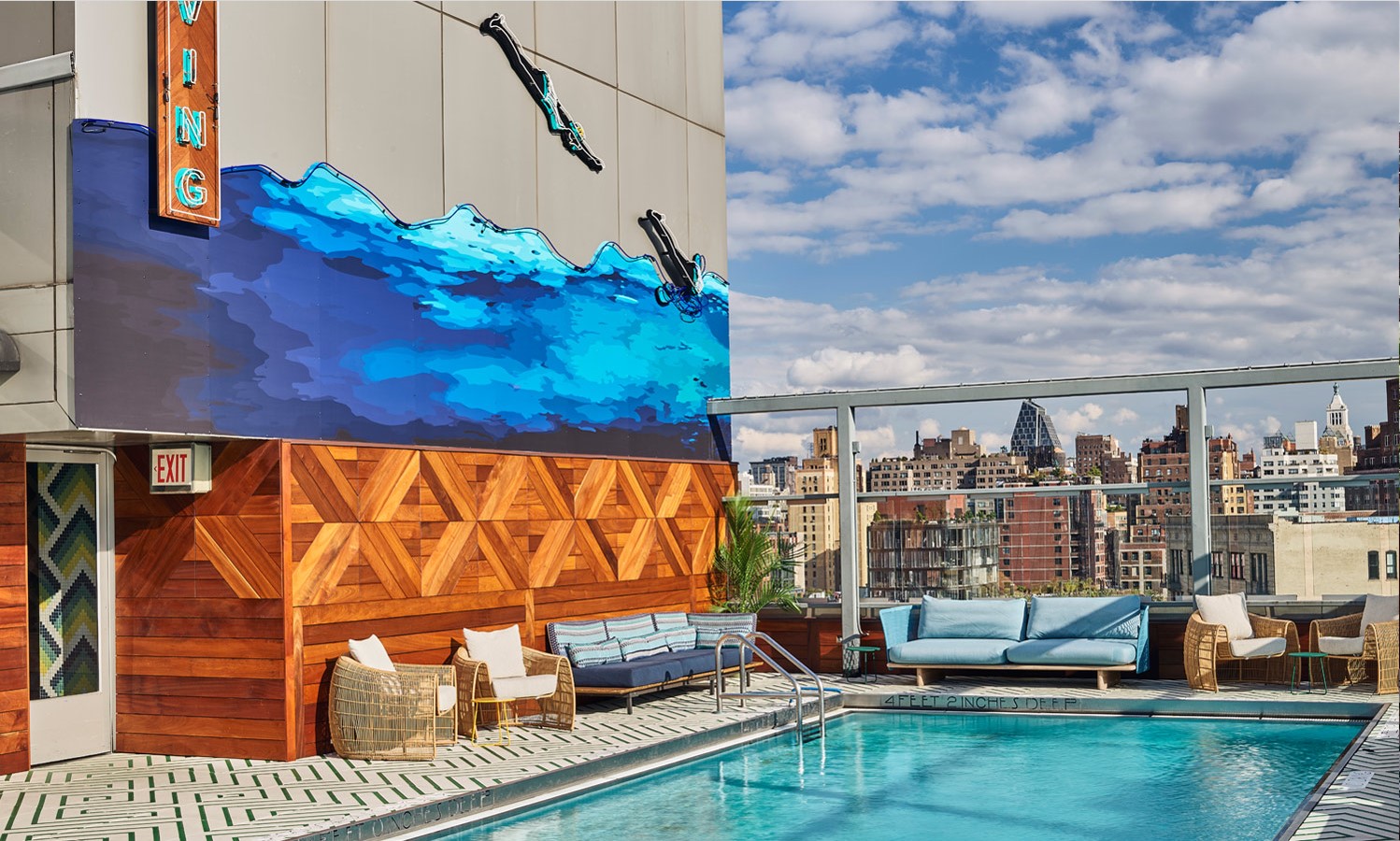 Wall mural on the side of hotel overlooking a swimming pool